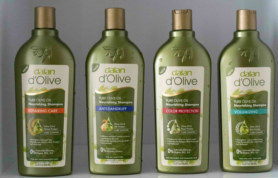 A group of d'Olive Hair Care shampoo bottles.
